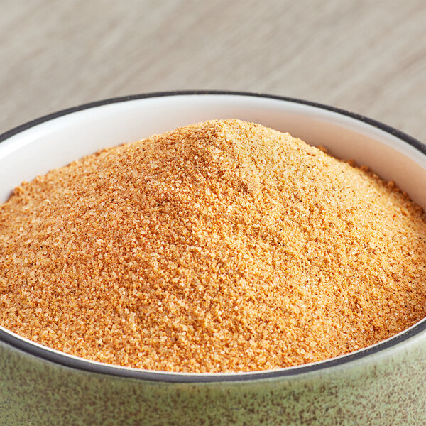 A bowl of yellow powdered McCormick Culinary Seasoned Meat Tenderizer.