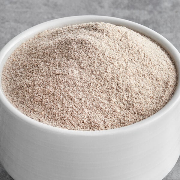 A bowl of brown Big Train Spiced Chai Tea Latte mix powder.