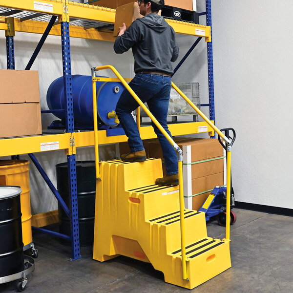 A yellow polyethylene four-step step stool with handrails and casters, designed for industrial use.