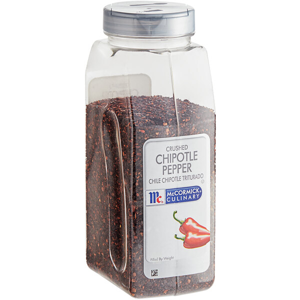 A plastic container of McCormick Culinary Crushed Chipotle Pepper with a red label and a white lid.