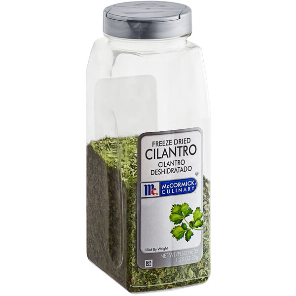 A plastic container of McCormick Culinary Freeze-Dried Cilantro with a green label and lid.
