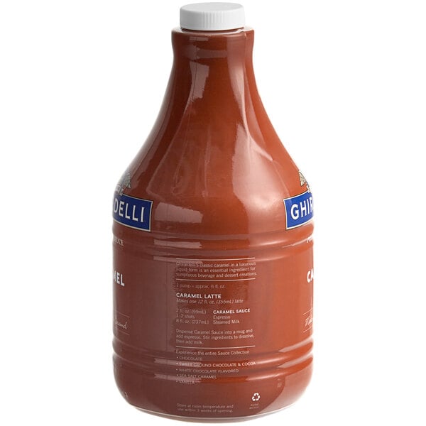 A brown Ghirardelli Caramel Flavoring Sauce bottle with a white label.