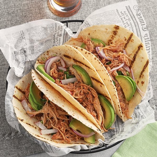 A group of tacos with McCormick Rotisserie Chicken seasoning, meat, and avocado.