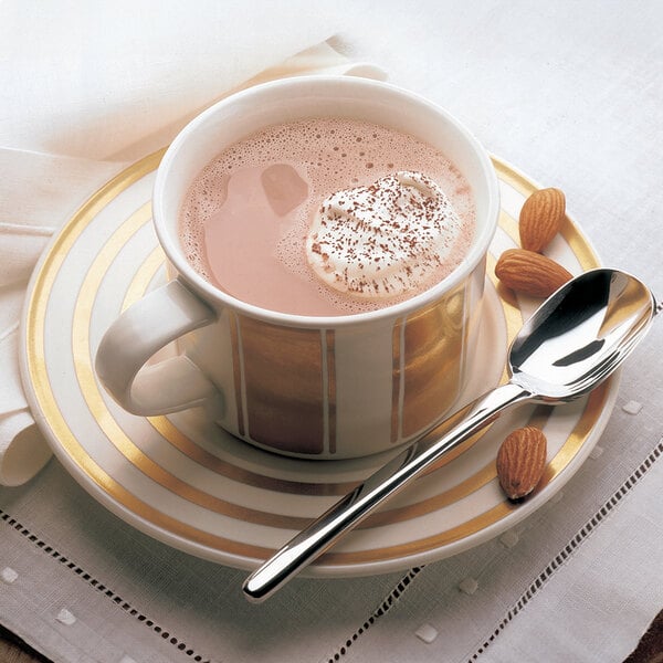 A spoon in a cup of HERSHEY'S Special Dark Chocolate hot chocolate with almonds.