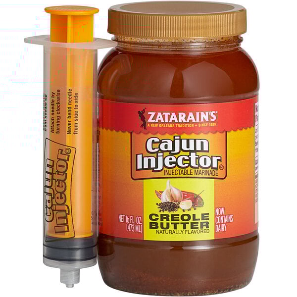 A jar of Cajun Injector Creole Butter Marinade with a syringe.