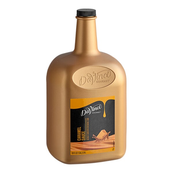 A 128 fl. oz. bottle of DaVinci Gourmet Caramel Flavoring Sauce with a black label.