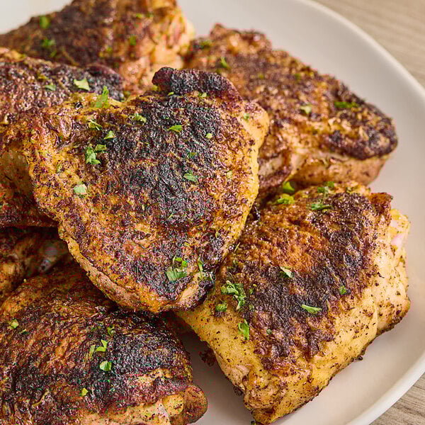 Cooked chicken seasoned with McCormick Culinary Blackened Seasoning on a plate.