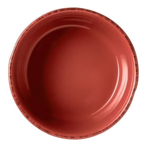 A close-up of a Libbey Farmhouse round barn red bouillon bowl with a brown rim.