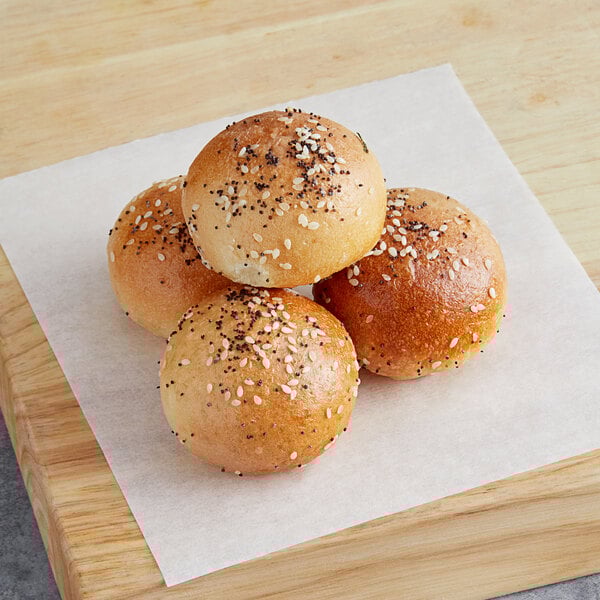 Poppy's Stuffed Everything Bagel Hole buns on a cutting board.
