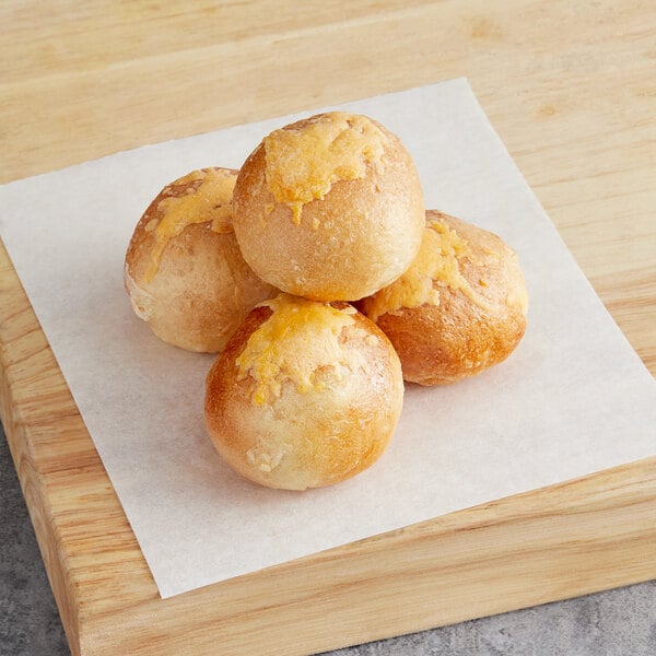 Poppy's Stuffed Jalapeno Cheddar Bagel Holes on a cutting board.