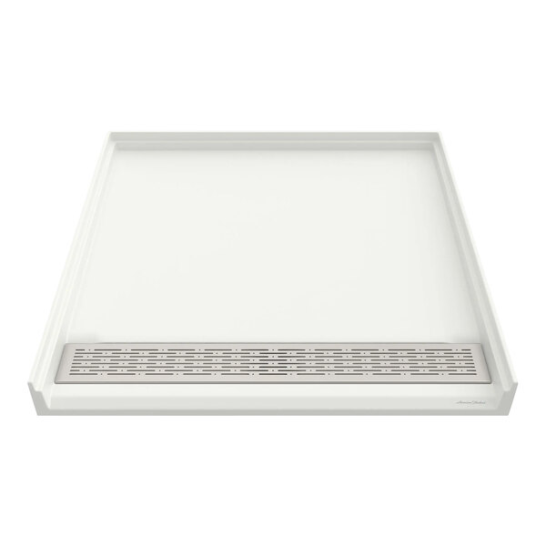 A white rectangular American Standard shower base with a center drain and metal grate.