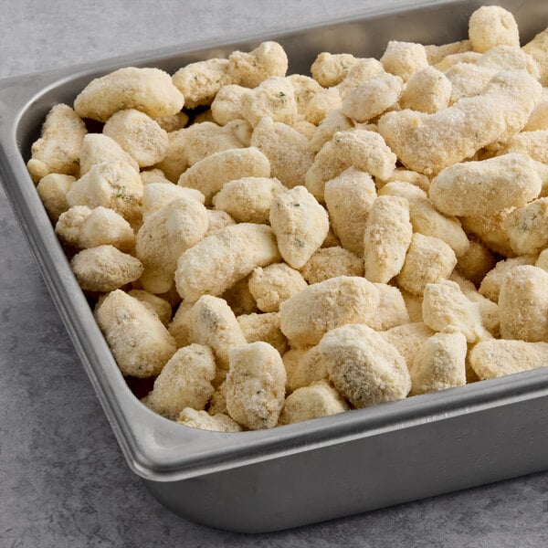 A metal tray filled with breaded garlic cheese curds.