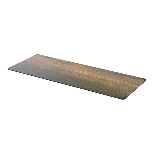 A rectangular wood table top with a walnut finish.