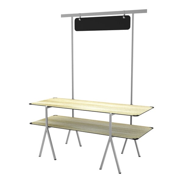 A wooden table top and shelf with a white stand and black chalkboard sign.