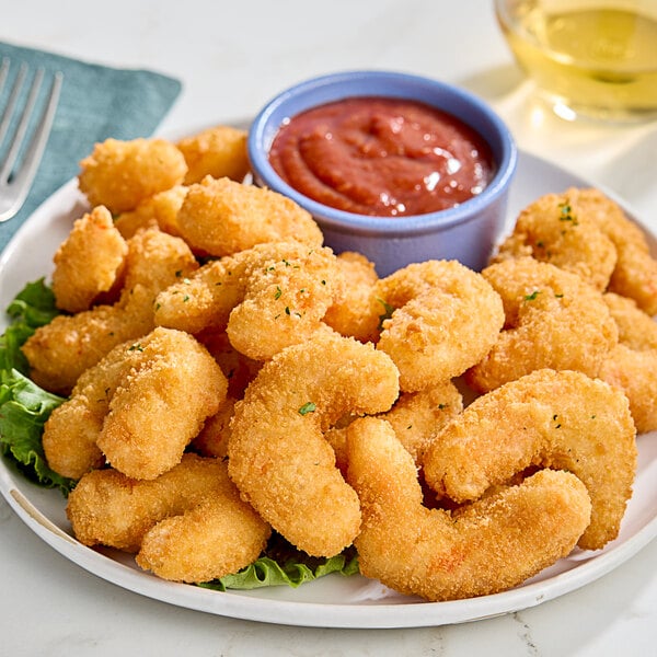 A plate of Mind Blown plant-based crispy fried shrimp with red sauce.