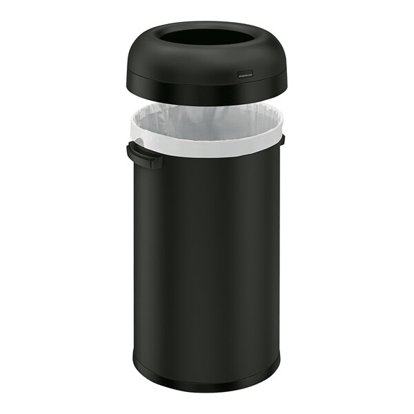 A simplehuman matte black steel round open top trash can with a plastic bag inside.