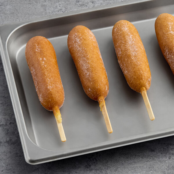 Foster Farms jalapeno cheese chicken corn dogs on a baking sheet.