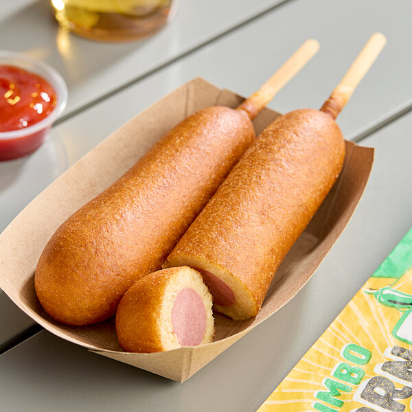 A Foster Farms jalapeno cheese chicken corn dog in a paper tray.