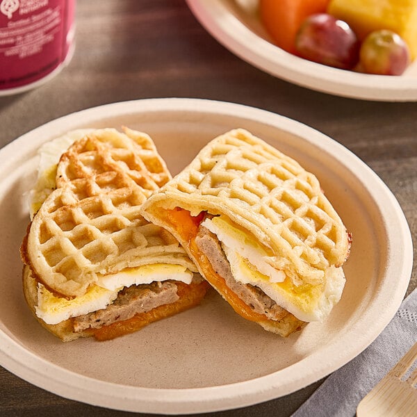 A Nordic Waffles sausage, egg, and cheese waffle sandwich on a plate.