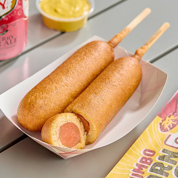 Two Foster Farms chili cheese chicken corn dogs in individual paper sleeves.