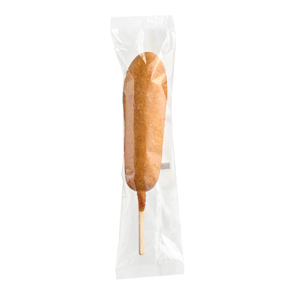 A Foster Farms Reduced-Sodium Whole Grain Corn Dog in a plastic wrapper.