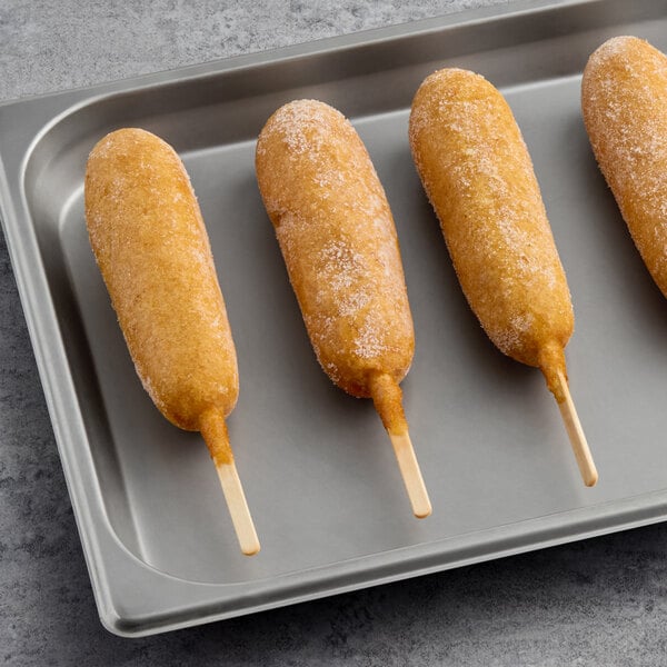 A tray of Foster Farms Honey Chicken Whole Grain Corn Dogs.