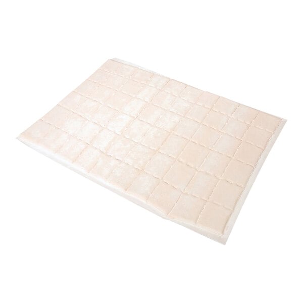 A white rectangular object of Bridgford Sopapilla Dough Bites on a white square tile.