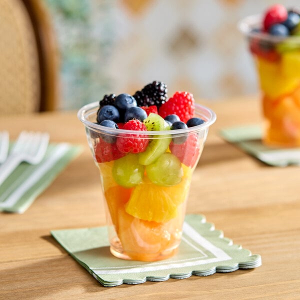 A clear 12 oz. plastic cup filled with assorted fresh fruit pieces.