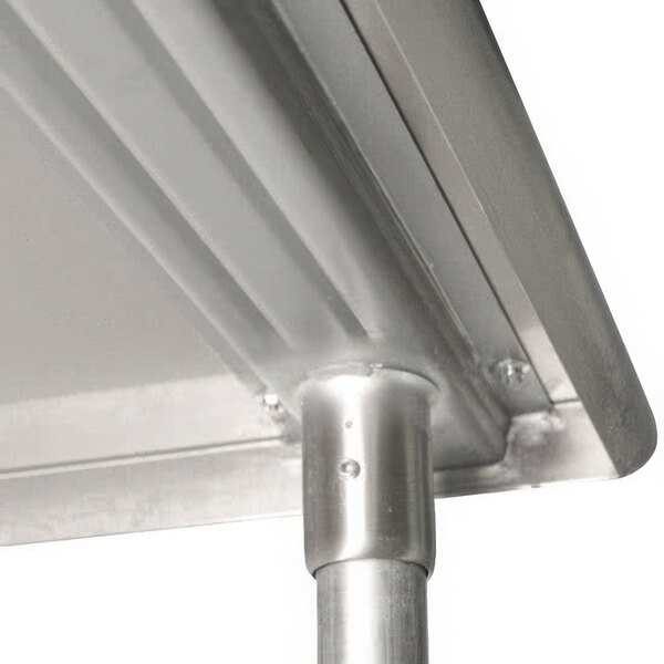 A close-up of a stainless steel metal table edge.