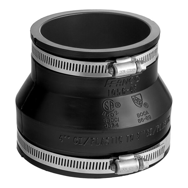 A Fernco 1056 flexible PVC pipe coupling with metal bands and black fittings.