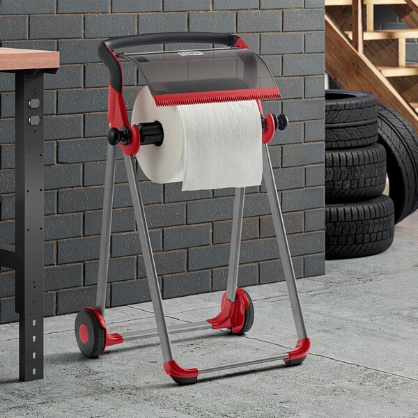 A portable floor stand wiper roll dispenser with a red and smoke color scheme, designed for holding and dispensing large rolls of wiper paper.