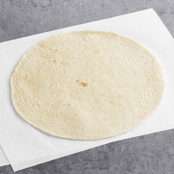 An El Mejor 12" flour tortilla on a white surface.
