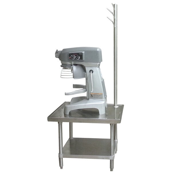 A stainless steel Advance Tabco mixer table with a machine on it.
