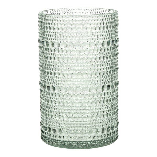 A sage plastic highball glass with a patterned design of circles on the bottom.