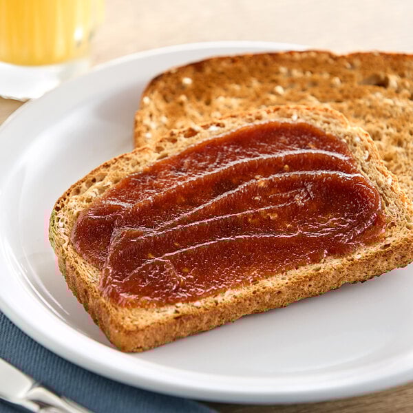 A piece of toast with White House apple butter spread on it.