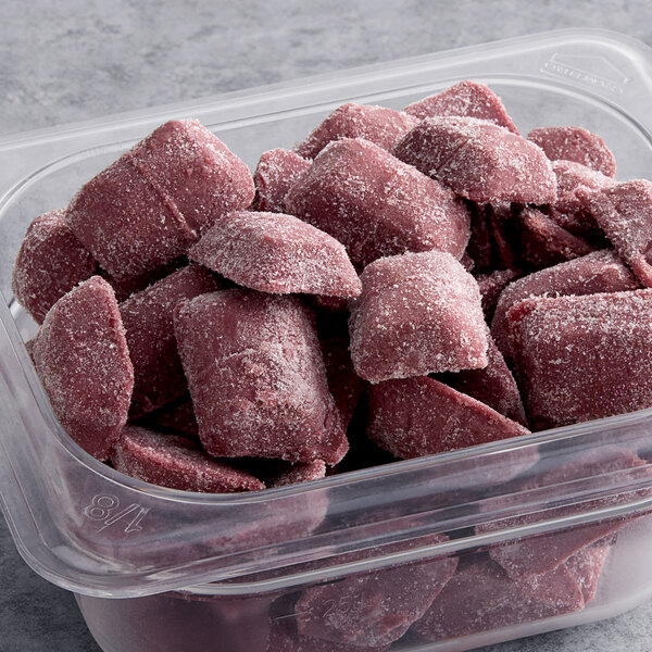 A plastic container of frozen Sambazon Organic Mixed Berries & Acai Smoothie cubes.