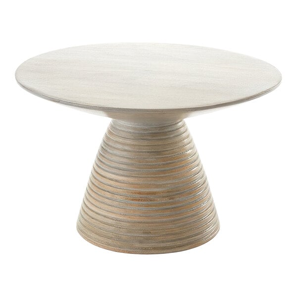 An American Metalcraft Hampton Collection round Sun-Bleached Mango Wood pedestal on a round wooden table.