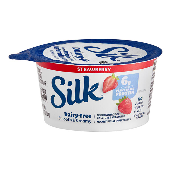 A container of Silk strawberry soymilk yogurt alternative with a strawberry on top.