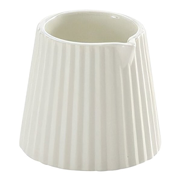An American Metalcraft white fluted ceramic creamer with a handle.
