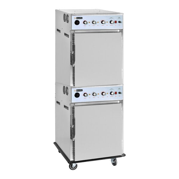 A stacked stainless steel cook and hold oven with smoker feature on caster wheels.