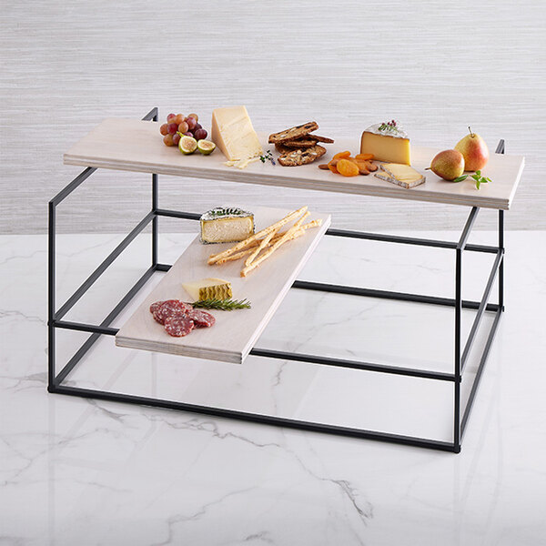 An American Metalcraft sun-bleached mango wood board with trays of food on a table.