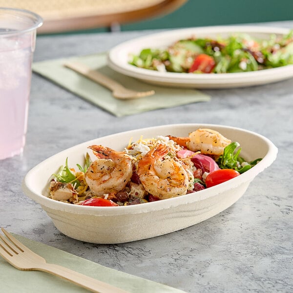 A Dart ProPlanet compostable burrito bowl filled with food on a table.