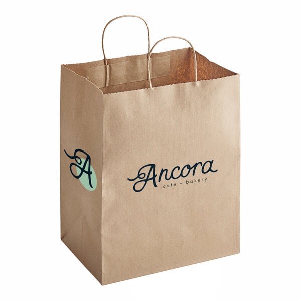 A natural kraft paper shopping bag with handles featuring the Ancora Cafe & Bakery logo.