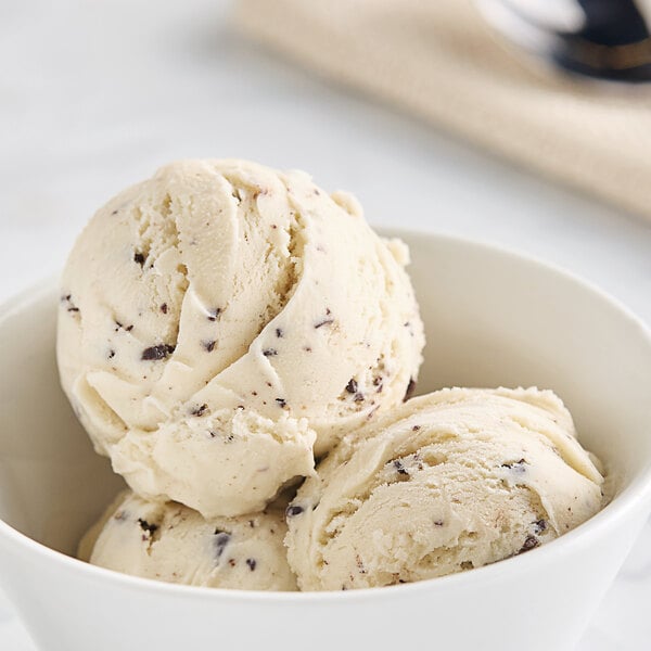 A close-up of a scoop of Bravo Gelato peanut butter chocolate chip gelato with chocolate chips.