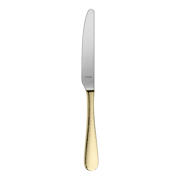 An Amefa Sierra stainless steel table knife with a gold handle.