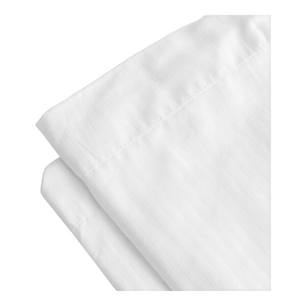 A close up of a folded white 1888 Mills Magnificence duvet cover with a tone on tone stripe pattern.