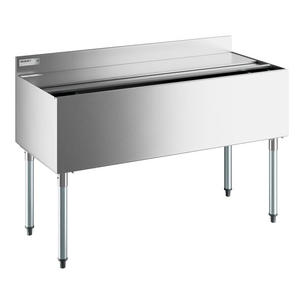 A Regency stainless steel underbar ice bin with bottle holders and a sliding lid.