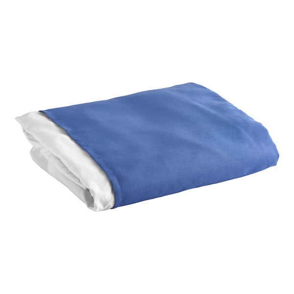 A folded blue and white 1888 Mills polyester bed skirt.