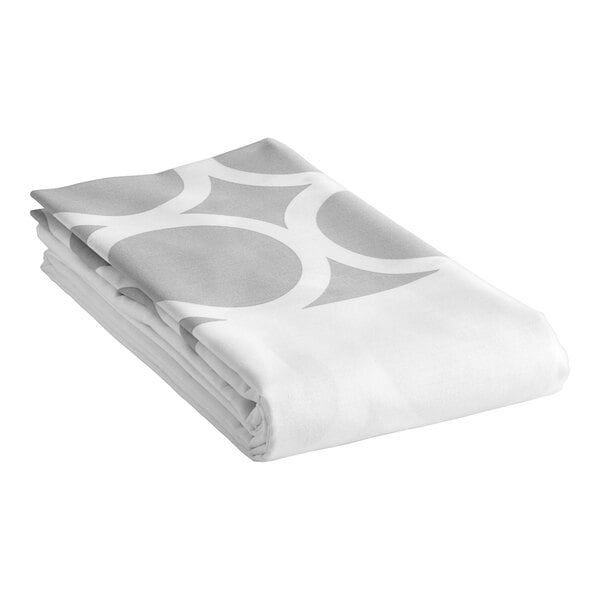 A folded 1888 Mills queen size top sheet with a white and grey circle design.