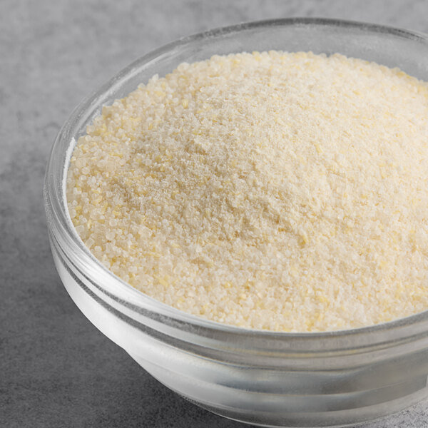 A bowl of True Citrus crystallized orange powder on a table.